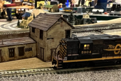 Rio Grande GP9 pulling past the junk yard while an SP sneaks by in the background